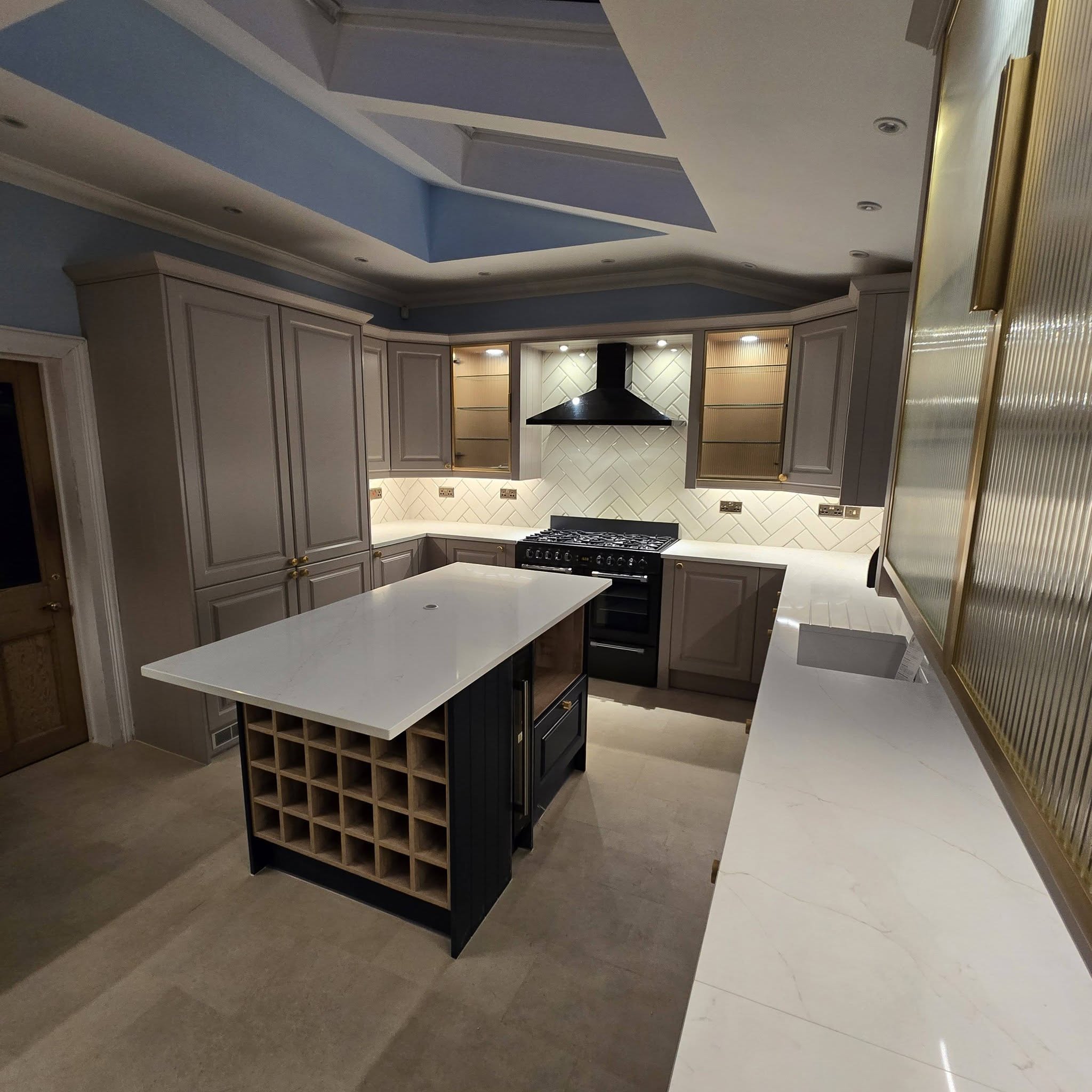 Shaker kitchen island with built-in wine rack and quartz worktop