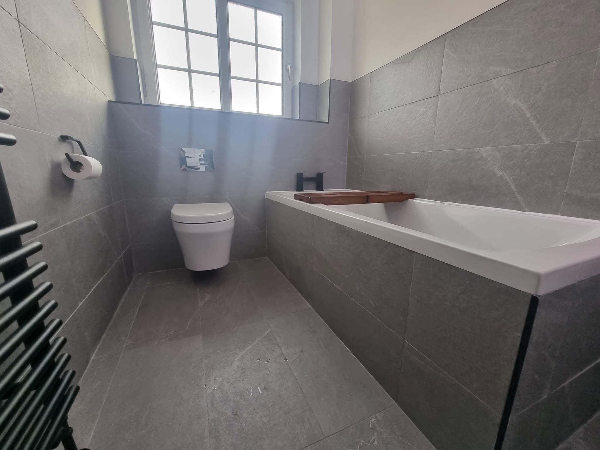 Refitted bathroom with built-in bath and wall-hung toilet