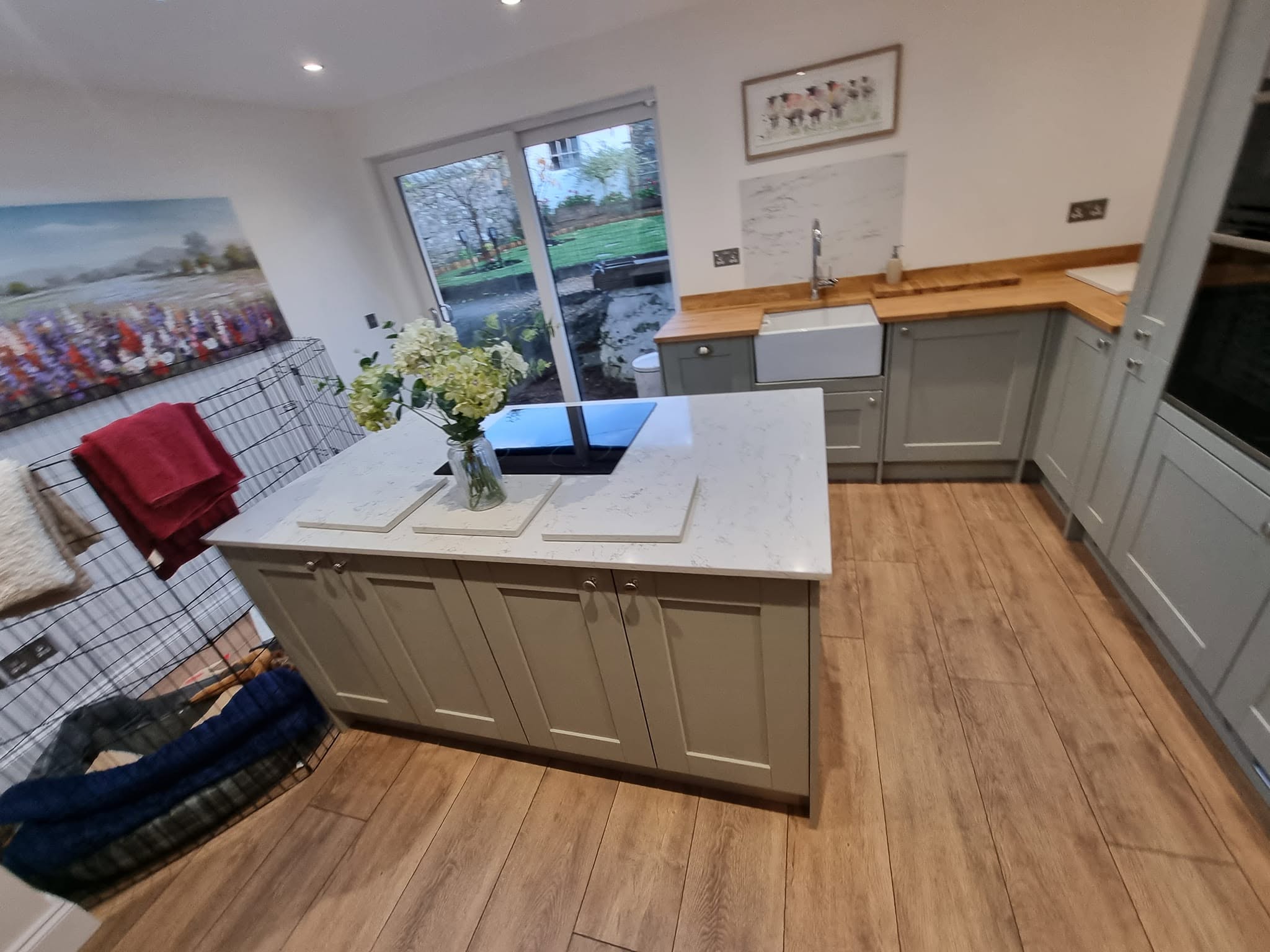 Open-plan kitchen with island fitted by Morgan Joinery Services
