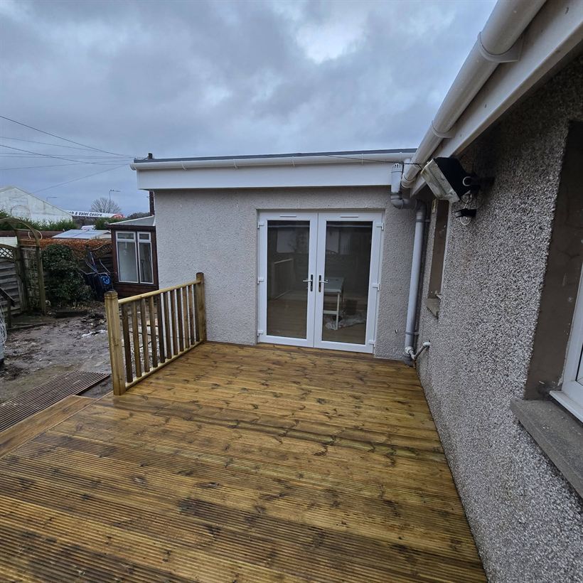 New decking with spindle balustrade and French doors
