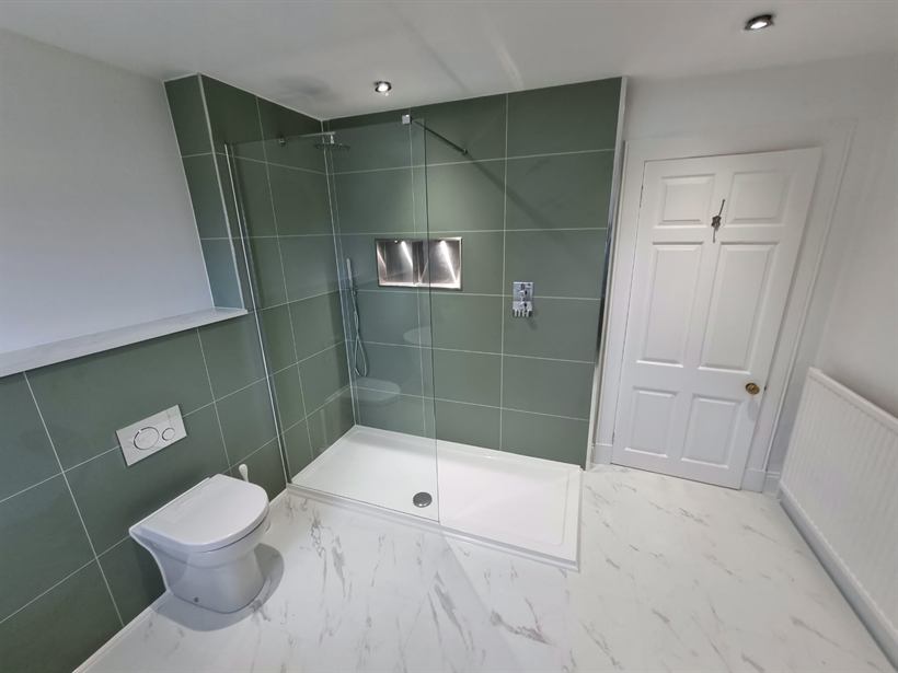 Sage tiled shower room